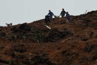 Rescue workers collect items at the site where China Eastern flight MU5375 crashed on March 21, near Wuzhou, in southwestern Chinas Guangxi province on March 24, 2022. (Photo by Noel Celis / AFP)