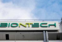 (FILES) In this file photo taken on March 27, 2021 the logo on the facade of the new manufacturing site of German company BioNTech for the production of the Covid-19 vaccine is seen in Marburg, central Germany. - Covid jab maker BioNTech said on Mai 10, 2021 it would build a Southeast Asia headquarters and manufacturing site in Singapore to produce hundreds of millions of mRNA-based vaccines per year, with construction of the site starting this year to become operational by 2023. (Photo by Thomas Lohnes / AFP)