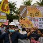 Protesters hold placards during an anti-government demonstration outside the Sri Lanka prime minister's official residence in Colombo on April 26, 2022, demanding President Gotabaya Rajapaksas resignation over the country's crippling economic crisis. (Photo by ISHARA S. KODIKARA / AFP)